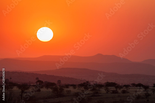 Africa, Namibia, Damaraland. Orange sunset over mountains.