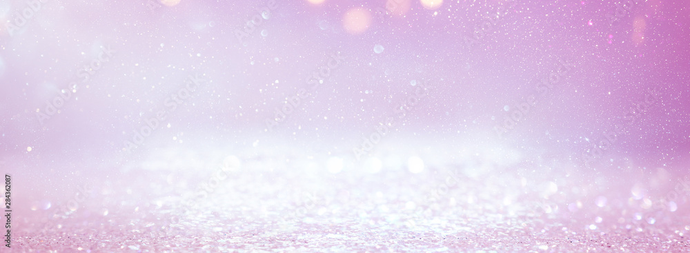 background of abstract glitter lights. purple, pink, gold and silver. de focused. banner