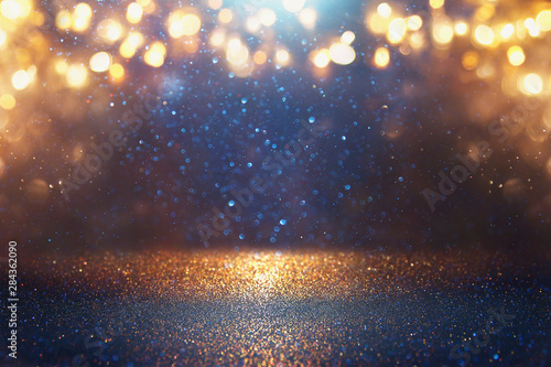 blackground of abstract glitter lights. blue, gold and black. de focused © tomertu