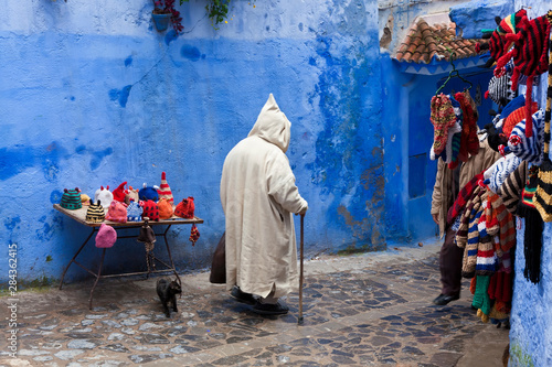 Man wearing a djellaba on the street, Chefchaouen, Morocco © Peter Adams/Danita Delimont