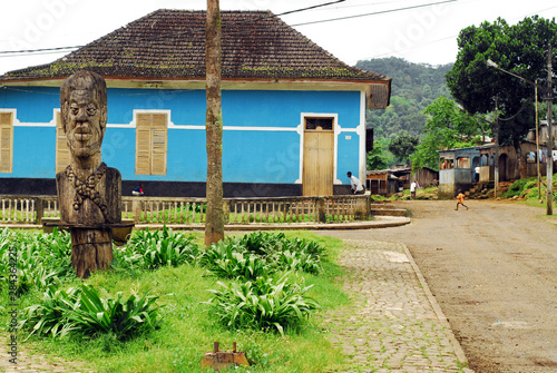 Photography Sao Tome, Angolares, big wooden carved statue in the middle of garden of the cen