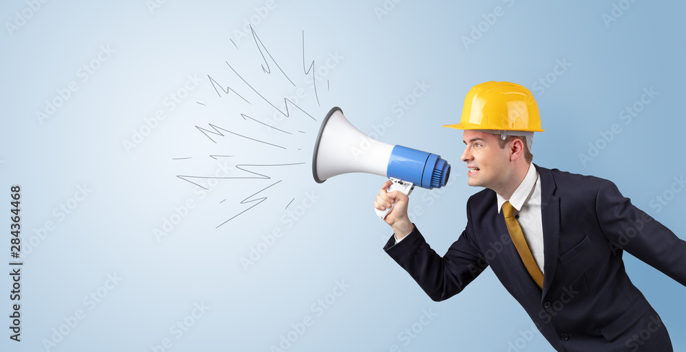 Young architect constructor yelling with megaphone and copyspace Young architect constructor yelling with megaphone and copyspace