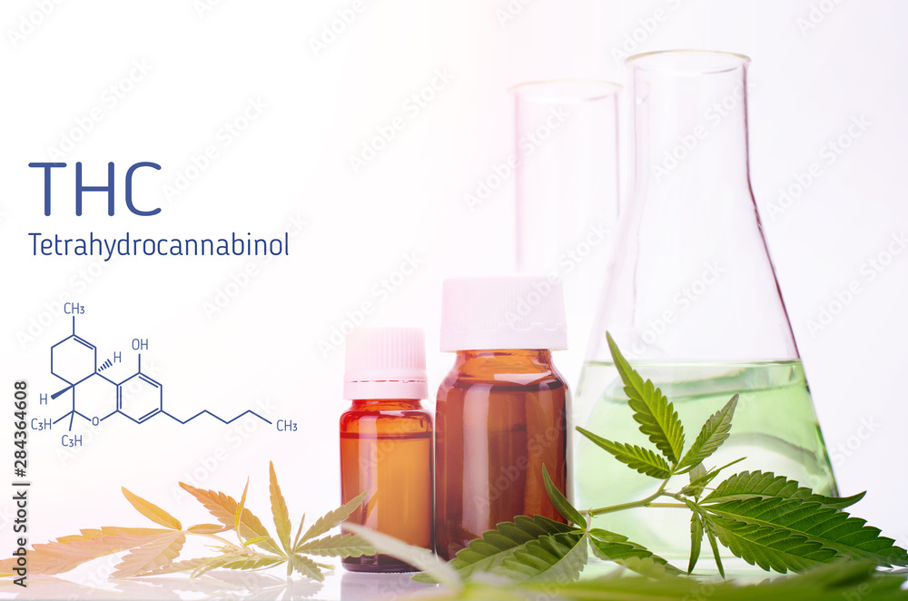 THC formula, Tetrahydrocannabinol. Medical, chemical theme with cannabis leaves, oil bottle and laboratory glass flasks behind on a white. THC formula, Tetrahydrocannabinol. Medical, chemical theme with cannabis leaves, oil bottle and laboratory glass flasks behind on a white.