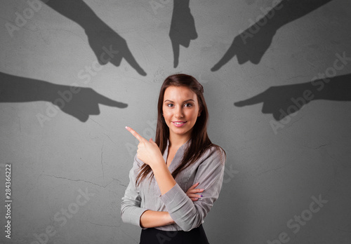 Φωτογραφία Young innocent student with pointing hands concept