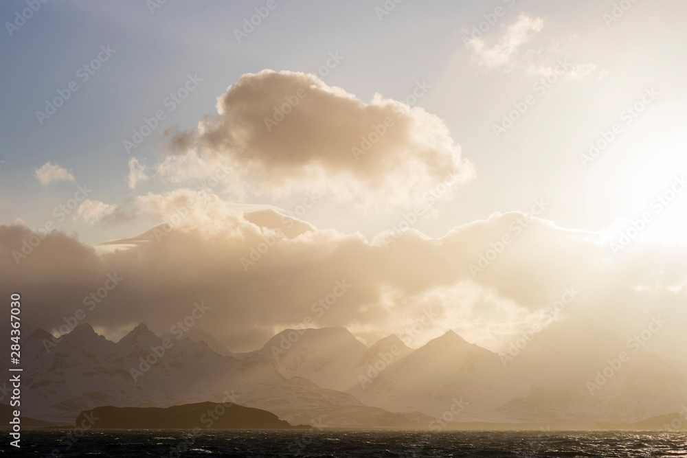 South Georgia Island, Bay of Isles. Storm clouds over mountains at sunset. Credit as Josh Anon / Jaynes Gallery / DanitaDelimont.com