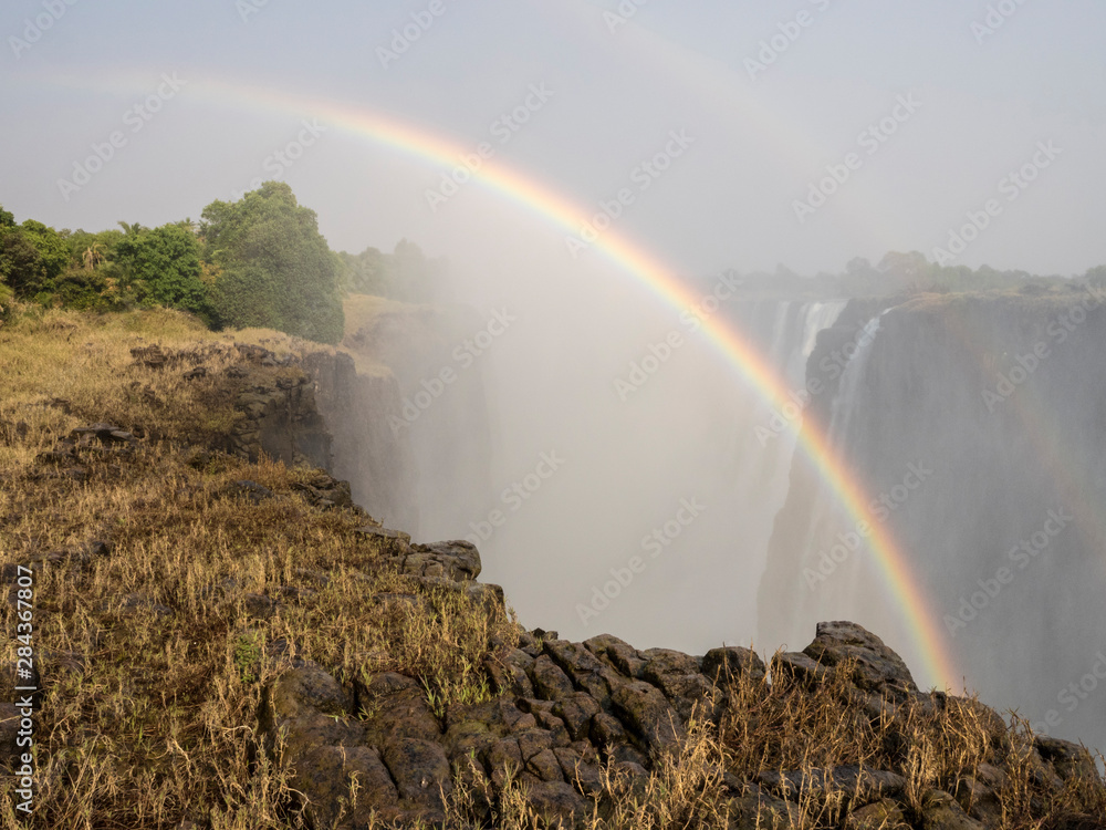 Africa, Zimbabwe, Victoria Falls. Rainbow over waterfall.