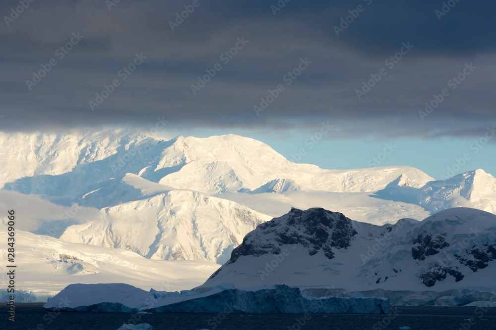 Antarctica. Paradise Harbor. Bright sunlight on the mountains beyond.