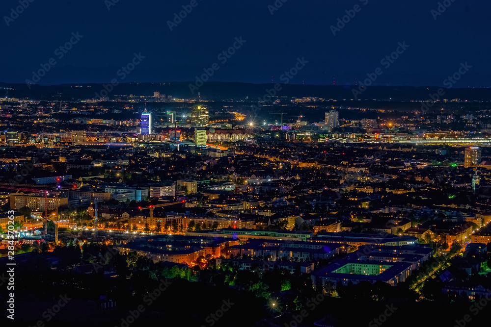 Aerial panoramic cityscape view with bright lights in night Munich