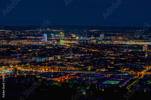 Aerial panoramic cityscape view with bright lights in night Munich