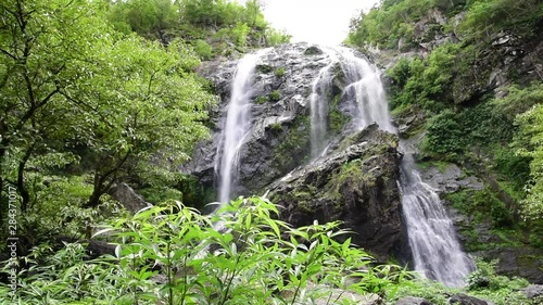 Klong Lan waterfall, the waterfall in Klong Lan National Park with trees foreground and beautiful falling water with rock background at Khlong Lan Phatthana, Kamphaeng Phet/Thailand photo