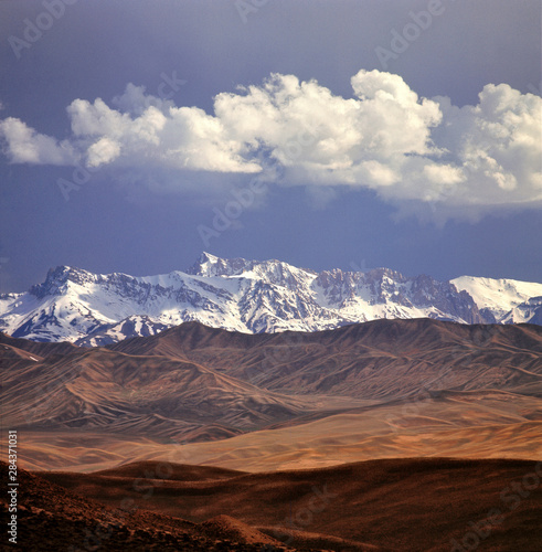 Afghanistan, Hindu Kush Mountains. Rolling foothills and the Hindu Kush Mountain Range near Bamiam, Afghanistan.