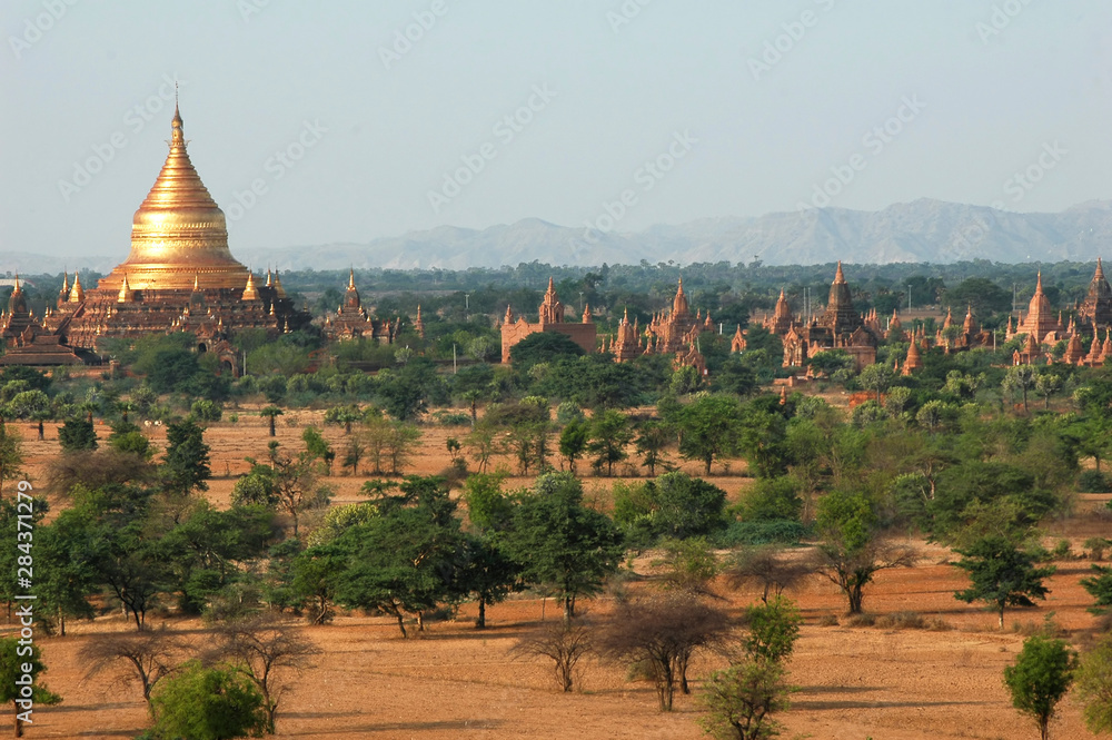 Myanmar, Bagan, Vast arid plain of ancient buddhist temples and bushes