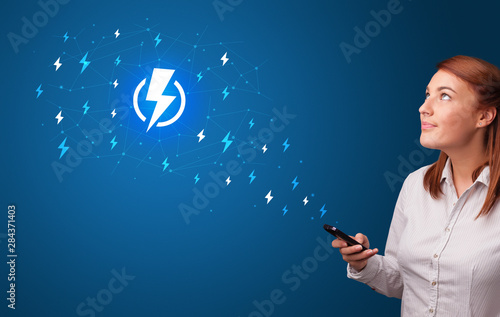 Young person using phone with power concept photo