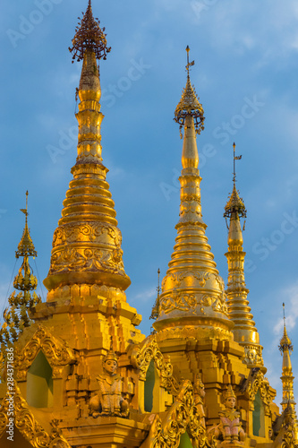 Myanmar. Yangon. Shwedagon Pagoda. Golden spires gleam at twilight.