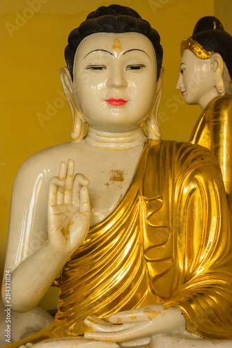 Myanmar. Yangon. Shwedagon Pagoda. Buddha with its hands in the discussion mudra.