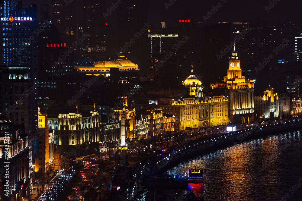 Night view of colonial buildings along the Bund by Huangpu River, Shanghai, China Night view of colonial buildings along the Bund by Huangpu River, Shanghai, China