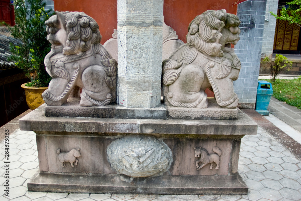Asia, China, Yunnan Province, Mojiang. Sculpture on gate support at Confucious temple includes lions and zodiac animal symbols