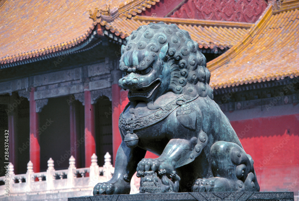 Naklejka premium Asia, China, Beijing. A statue of a powerfully-built lion guards the Forbidden City, a World Heritage Site, Beijing, China.