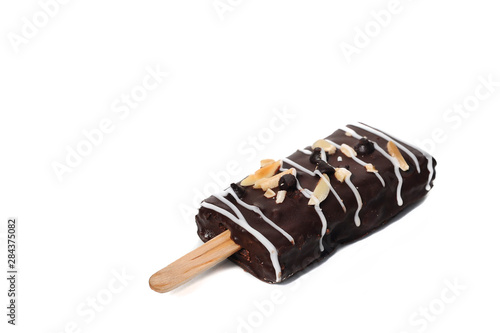 Sweet dark brownie stick with almond slice and white chocolate strips isolaed on white background.