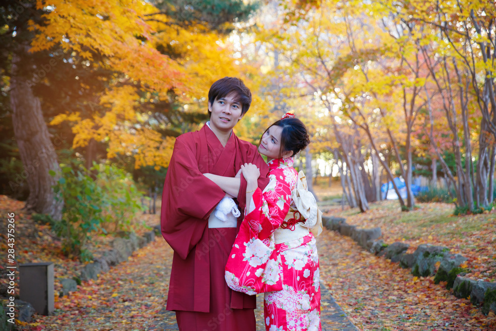 Young couple in love outdoor. Stunning sensual outdoor portrait of lover wearing japanese traditional kimono in autumn. love, relationship, season, family and people concept. Young couple in love outdoor. Stunning sensual outdoor portrait of lover wearing japanese traditional kimono in autumn. love, relationship, season, family and people concept.