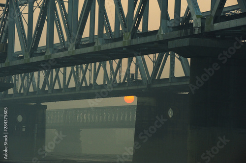 India, Bihar, Patna, Sonepur, Sonepur Mela Cattle Fait (largest in Asia), sunrise over bridge and Gandak river photo