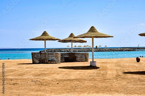 beach with chairs and umbrellas