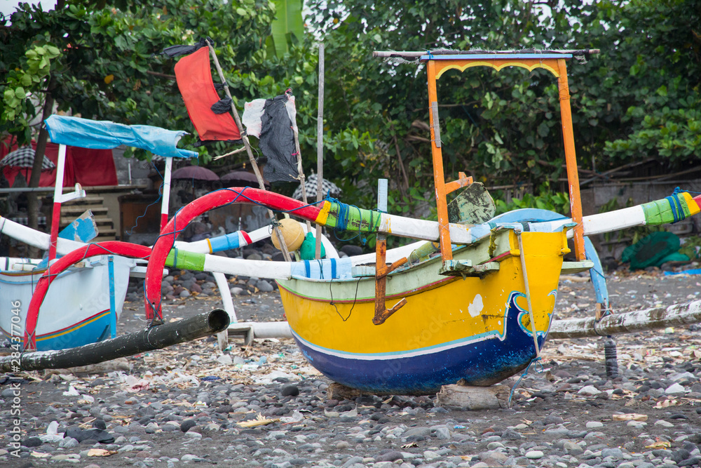 Indonesia, Bali. fishing boat along the Bali coast, resting on shore.