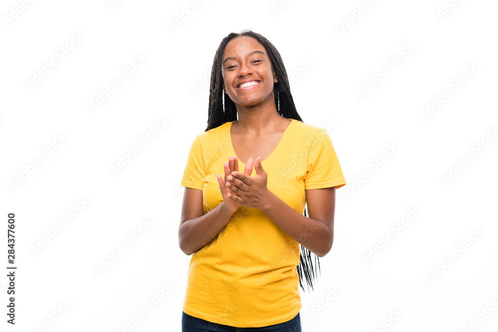 African American teenager girl with long braided hair over isolated white background applauding African American teenager girl with long braided hair over isolated white background applauding