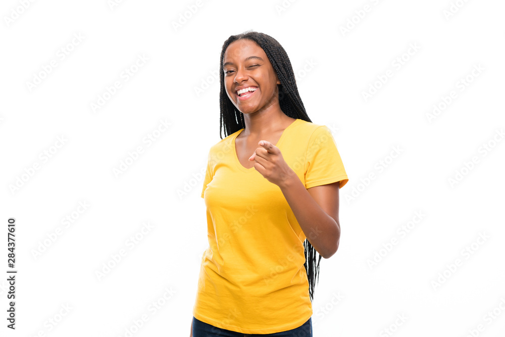 African American teenager girl with long braided hair over isolated white background points finger at you African American teenager girl with long braided hair over isolated white background points finger at you