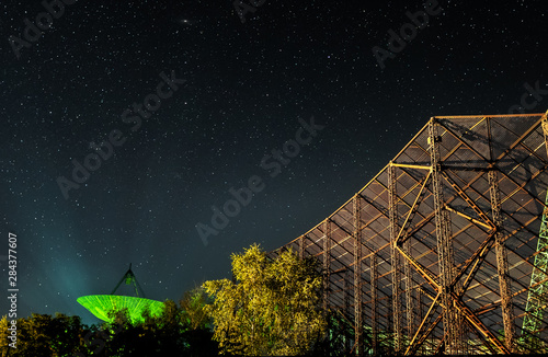 Space picture - a plate of the station of exploration of an ionosphere against the background of the night star sky. Big reflector like a metal net, which catching a stars.
