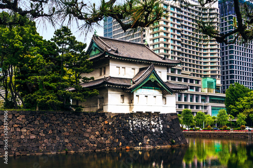 Tokyo, Japan. Imperial Palace, Edo Castle, with guard house and moat surrounded by modern city buildings