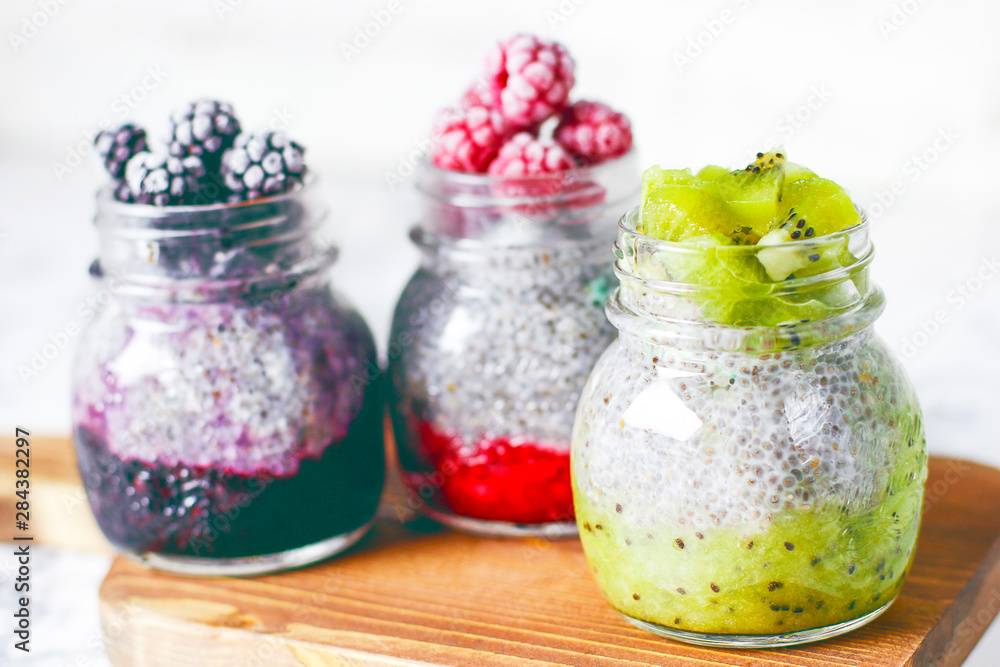 Chia pudding with berries ,raspberry sauce,kiwi sauce,blackberry sauce and frozen raspberries and blackberries and kiwi slices, healthy breakfast, vitamin snack, diet and healthy eating Chia pudding with berries ,raspberry sauce,kiwi sauce,blackberry sauce and frozen raspberries and blackberries and kiwi slices, healthy breakfast, vitamin snack, diet and healthy eating
