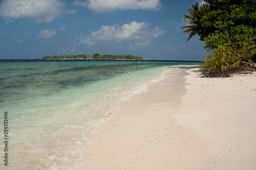 Fototapeta Naklejka Na Ścianę i Meble -  Maldives, North Male Atoll, Island of Kuda Bandos. View of the resort island of Bandos from the white sand beach of adjacent island.