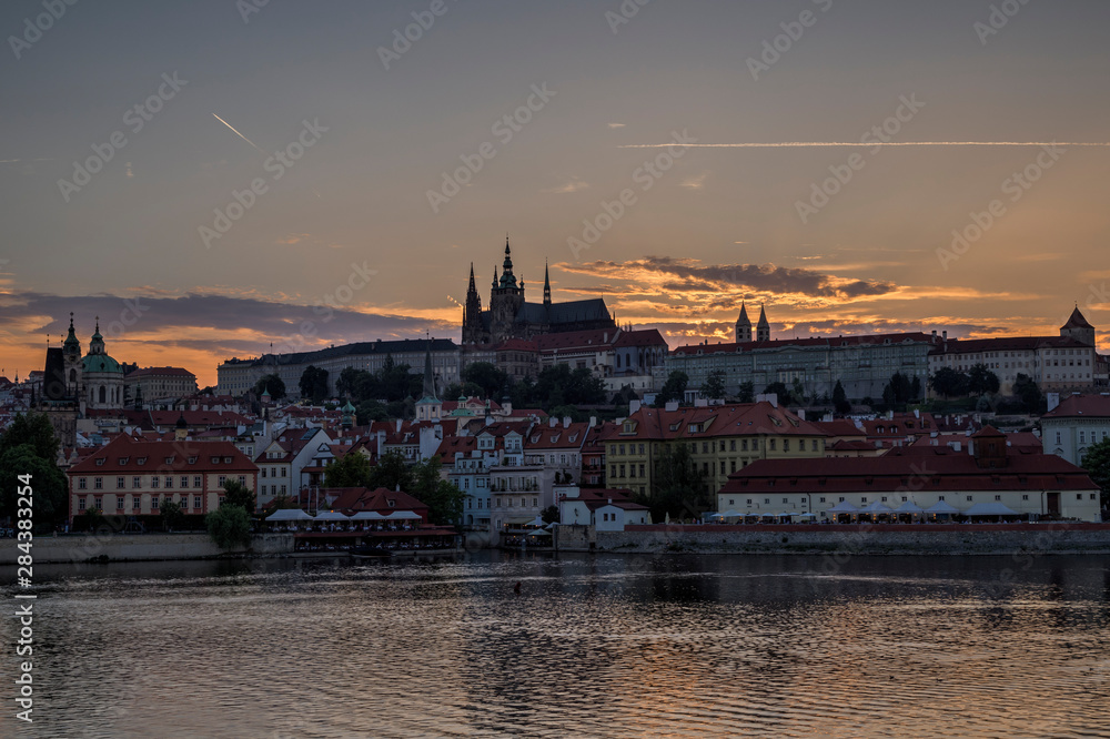 Fototapeta premium View of the Vltava River, Mala Strana district and Prague (Hradcany) Castle in Prague, Czech Republic, at sunset. Copy space.