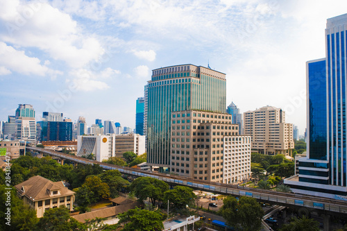 Bangkok, Thailand - The downtown buildings of a city and residential area are separated by an elevated roadway.