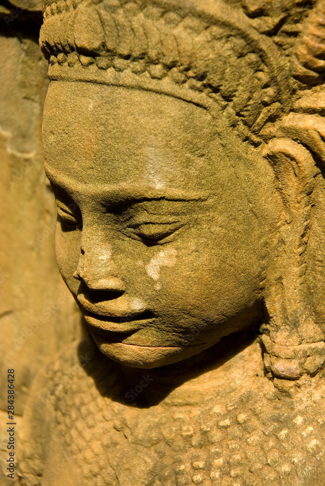 Fototapeta premium Cambodia. Siem Reap. Angkor Thom. Carved diety on a temple wall.
