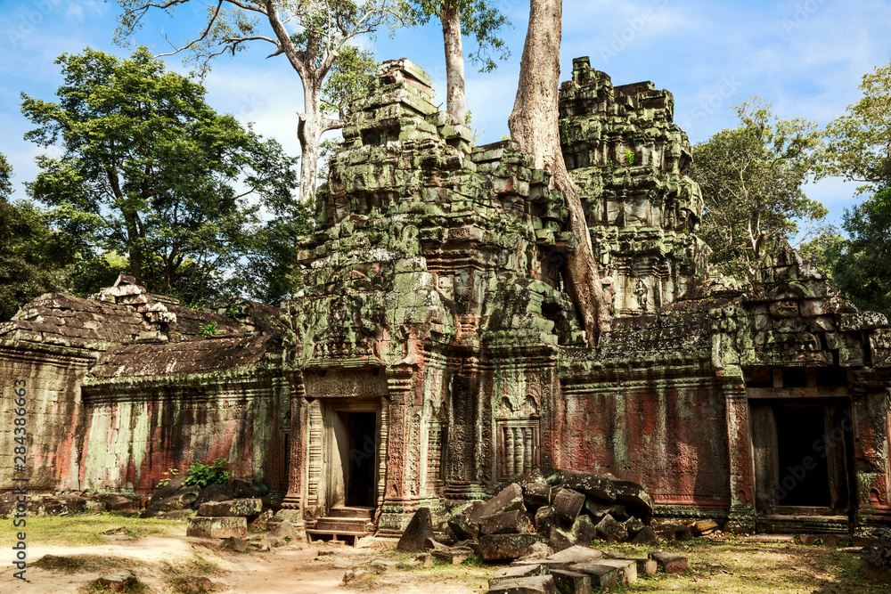 Siem Reap, Cambodia. Giant trees and roots overgrow the ancient ruins and towers of Ta Phrom Temple Siem Reap, Cambodia. Giant trees and roots overgrow the ancient ruins and towers of Ta Phrom Temple