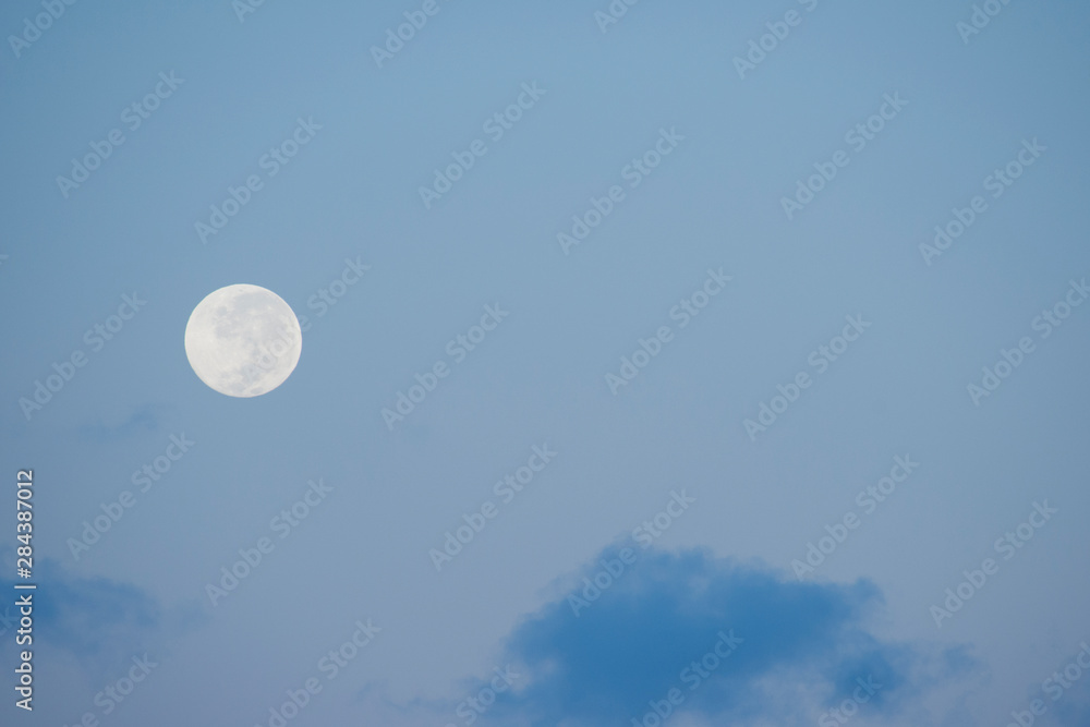 Australia, Northern Territory, Darwin. Full moon, moonrise with blue sky. Australia, Northern Territory, Darwin. Full moon, moonrise with blue sky.