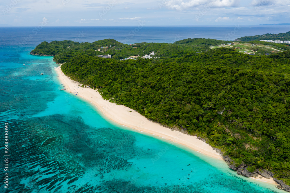 Aerial drone view of the beauiful sandy, tropical beach of Pukka Shell on Boracay Island, Philippines