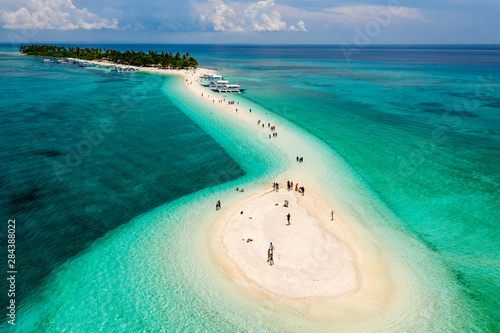 Aerial drone view of a beautiful tropical island with sandy beach surrounded by Coral Reef (Kalanggaman Island, Philippines) photo