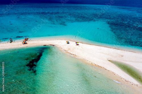 Aerial drone view of a spectacular sandbar surrounded by coral reef located off a tropical island (White Island, Camiguin, Philippines) photo