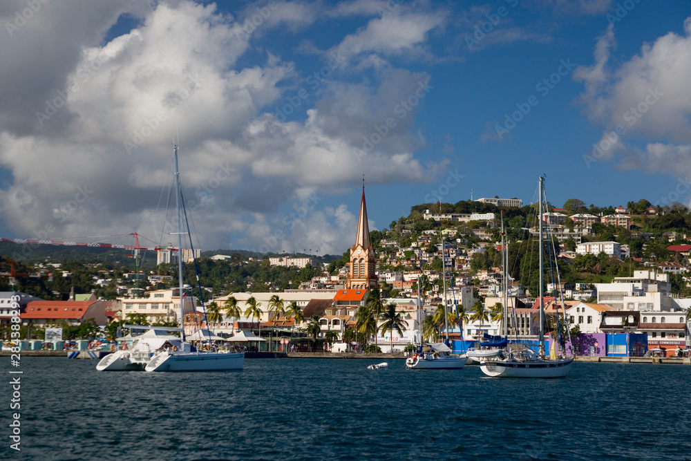 MARTINIQUE. French Antilles. West Indies. City of Fort-de-France below cumulus clouds. Steeple of St. Louis Cathedral is visible.