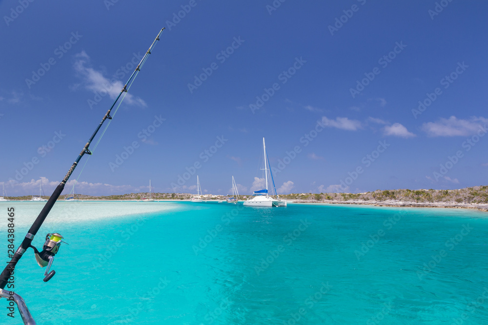Bahamas, Exuma Island, Cays Land and Sea Park. Moored sailboats and fishing rod. Credit as: Don Paulson / Jaynes Gallery / DanitaDelimont.com