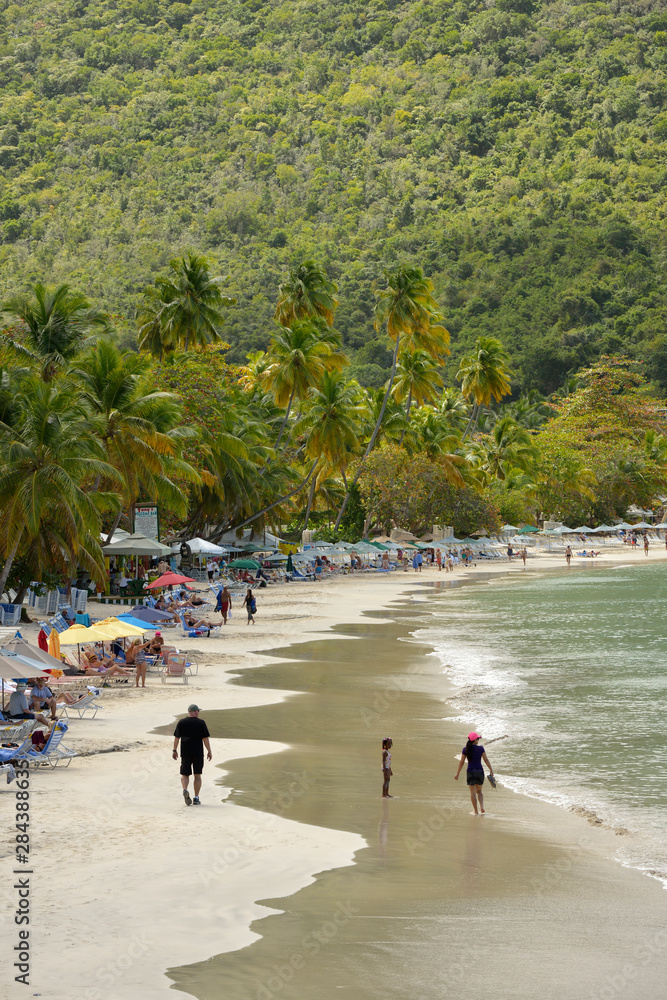 British Virgin Islands, Sandy Cay, Tortola. People walking on the beach at Cane Garden Bay