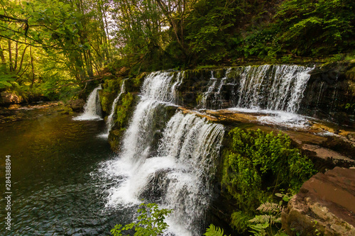 A scenic waterfall surrounded by forest in South Wales (Sgwd y Pannwr, Waterfall country, Wales) © whitcomberd