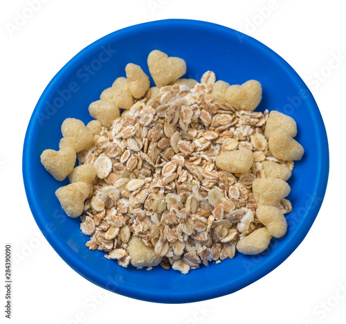 healthy breakfast on a plate isolated on white background.muesli with cornflakes, raisins, dates, pears and pineapple dried cashew nuts.breakfast top view photo