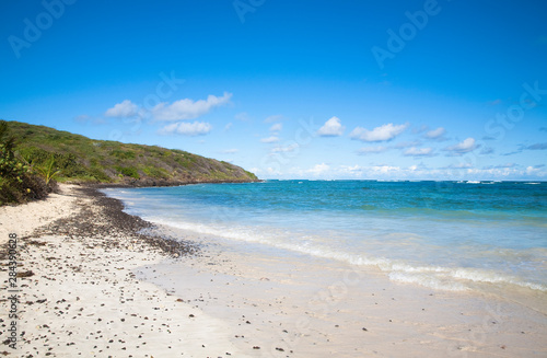 Vieques, Puerto Rico - Gentle waves are rolling up onto the white sands of a tropical beach.