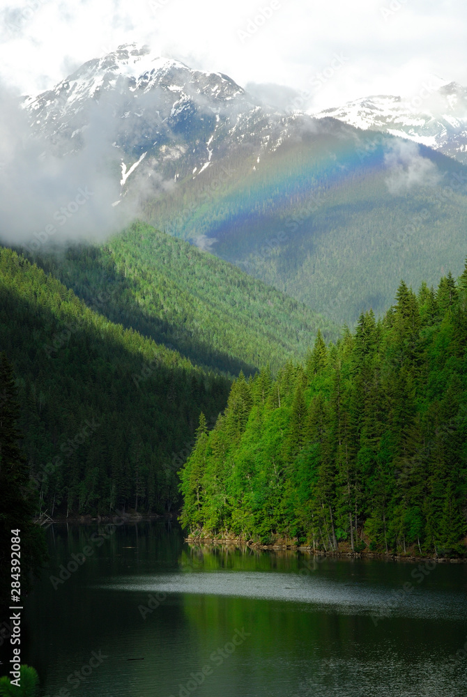 Canada: British Columbia, rainbow between Cache Creek (tribuaty into Lake Revelstoke, part of Columbia river) and Mount Iconoclast