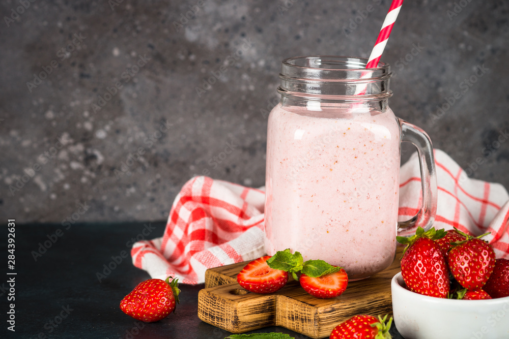Strawberry milkshake or smoothie in mason jar. Strawberry milkshake or smoothie in mason jar.