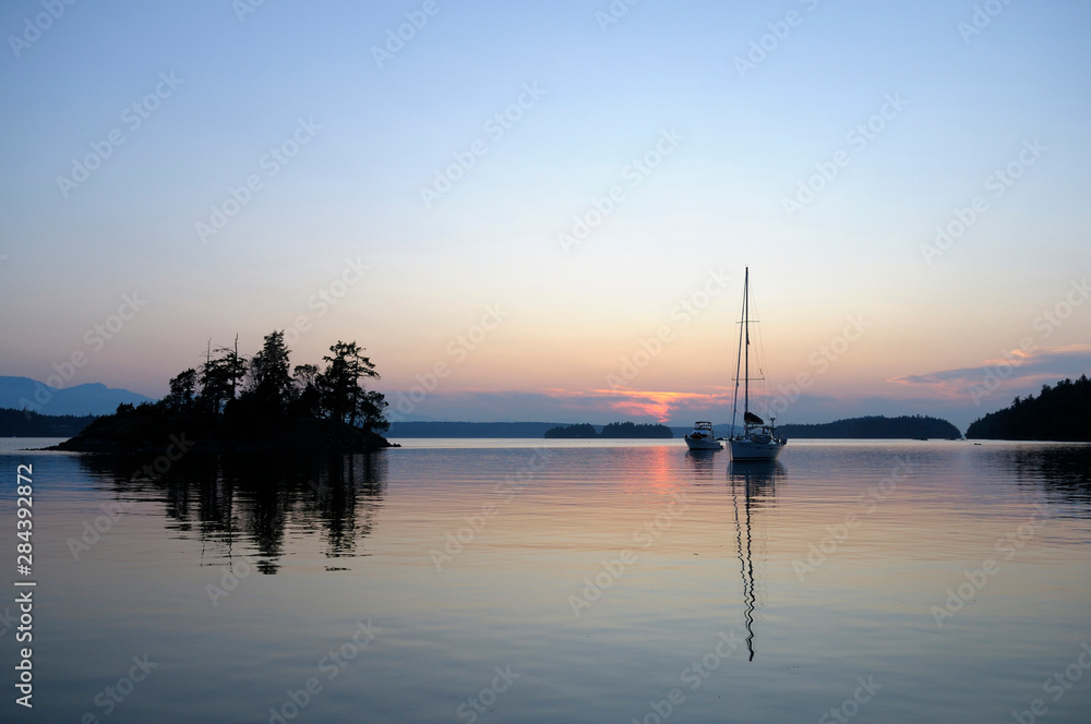 Canada, British Columbia, Gulf Islands, Wallace Island. Boats anchored on a calm ocean at sunset